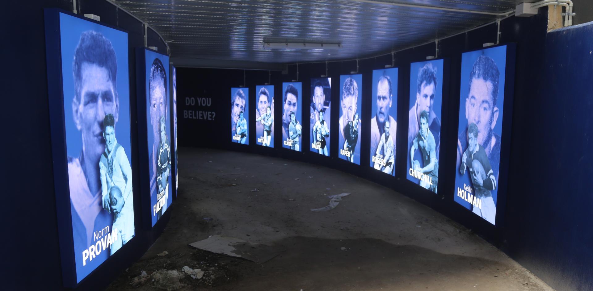 NSW Rugby players displayed on screens in hallway