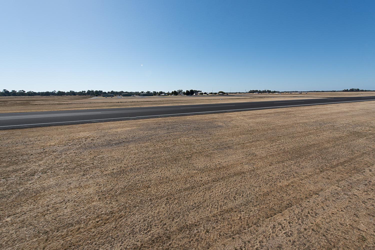 View of airport runway on clear blue sky day