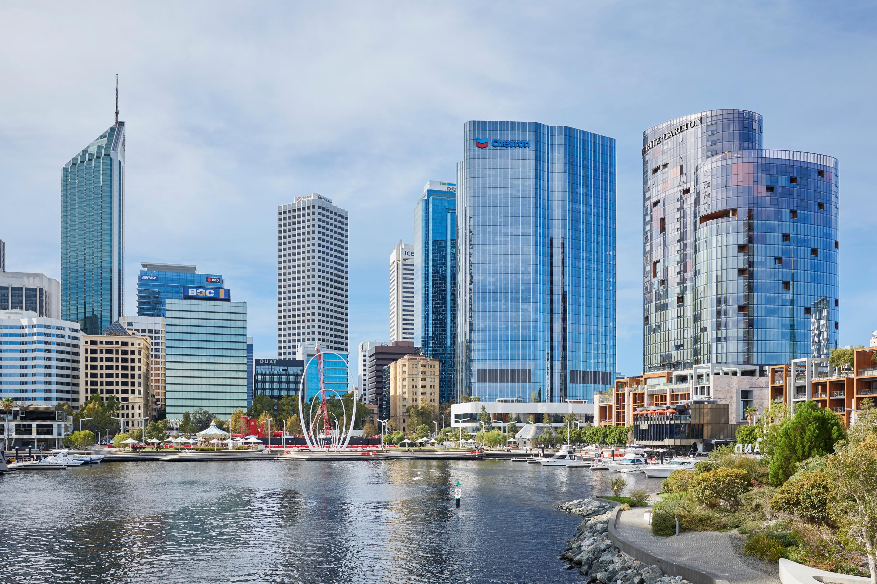 High-rise buildings and green spaces overlooking a river winding through the city