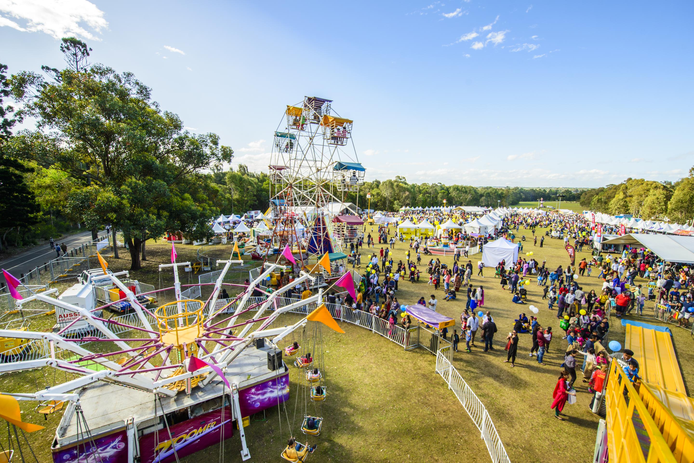Overhead photo of Parramatta Park showcasing ferris wheel, crowds and tents