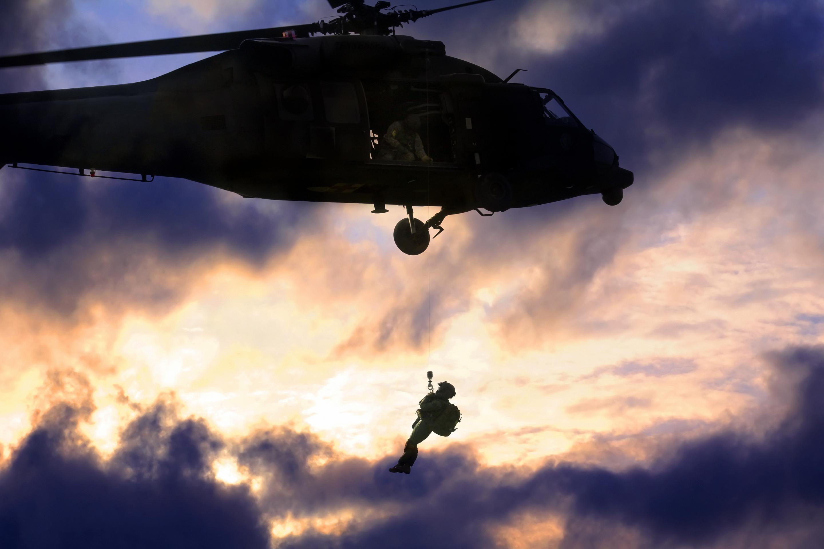 Soldier being lifted by a helicopter