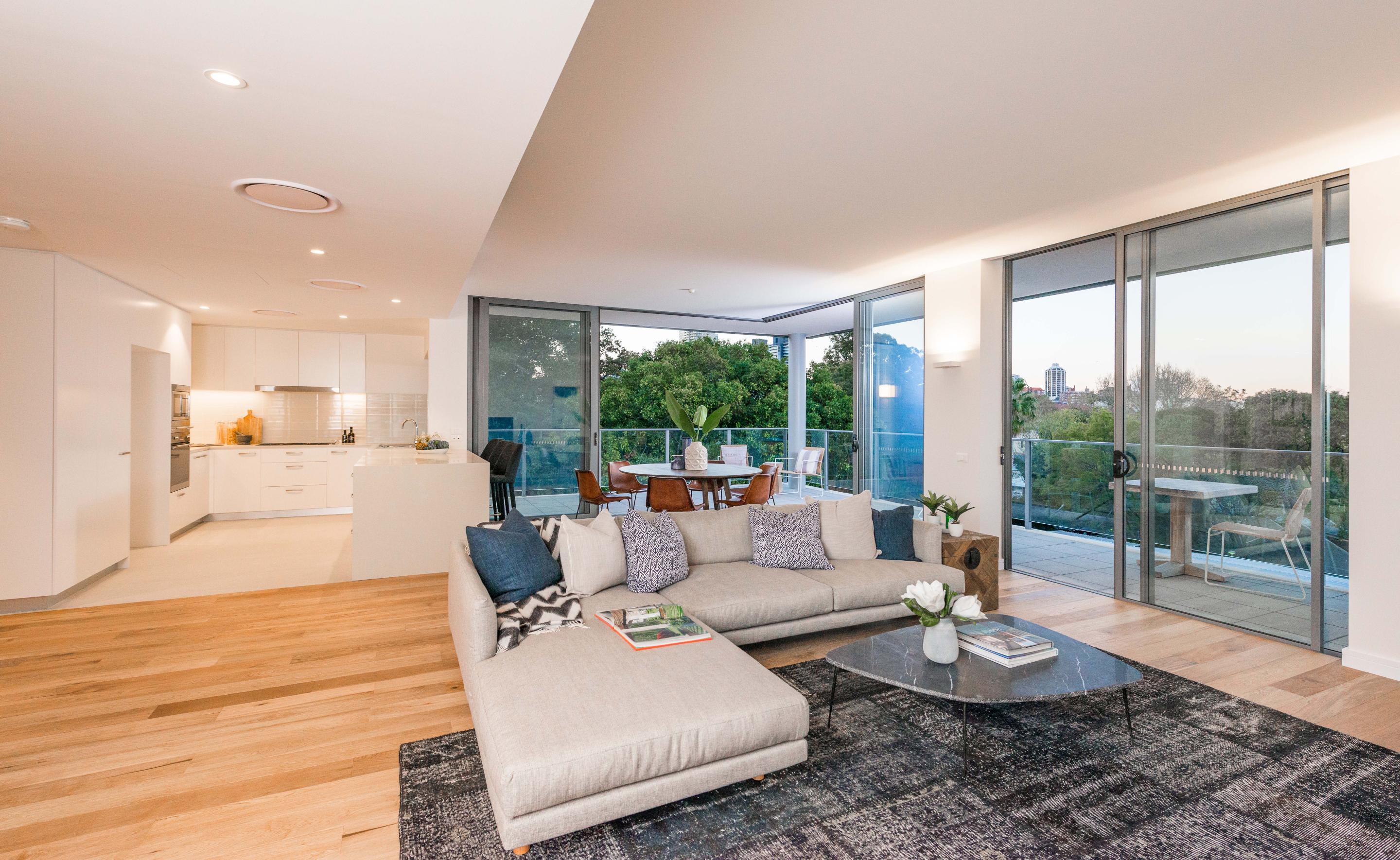 Interior of house showing well lit living room and kitchen