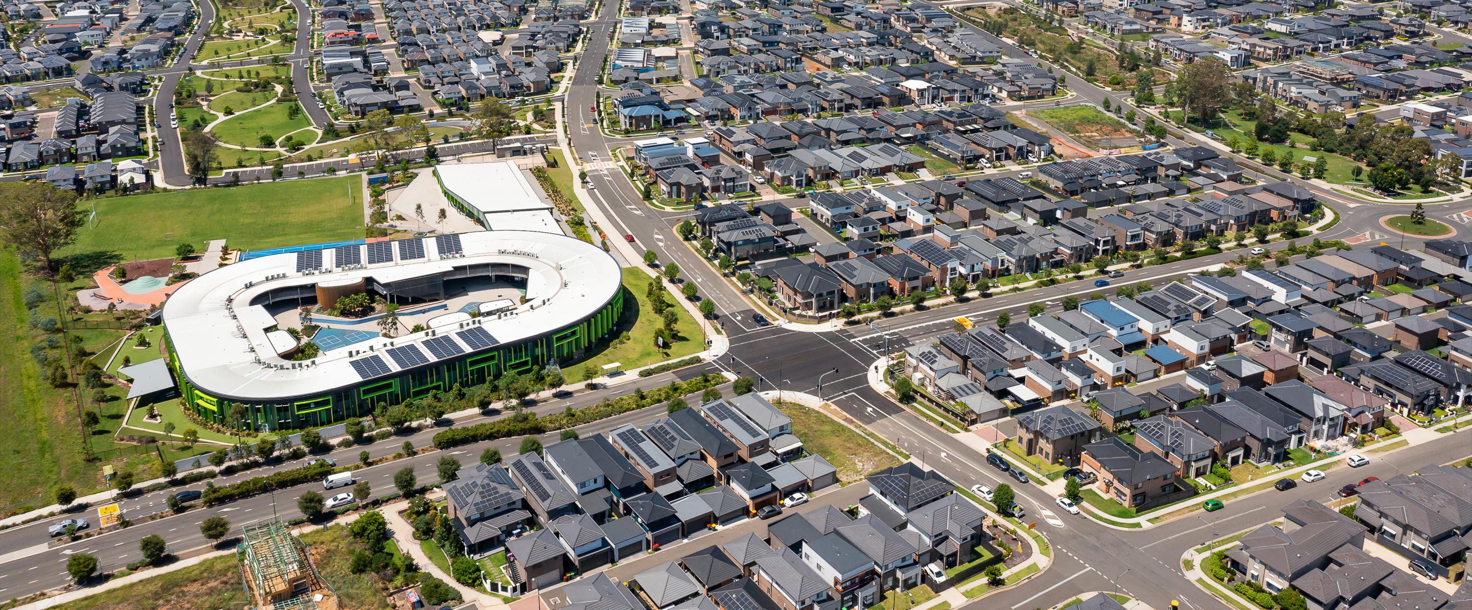 Overhead photograph of Western Sydney suburb, houses, roads, and sports centre