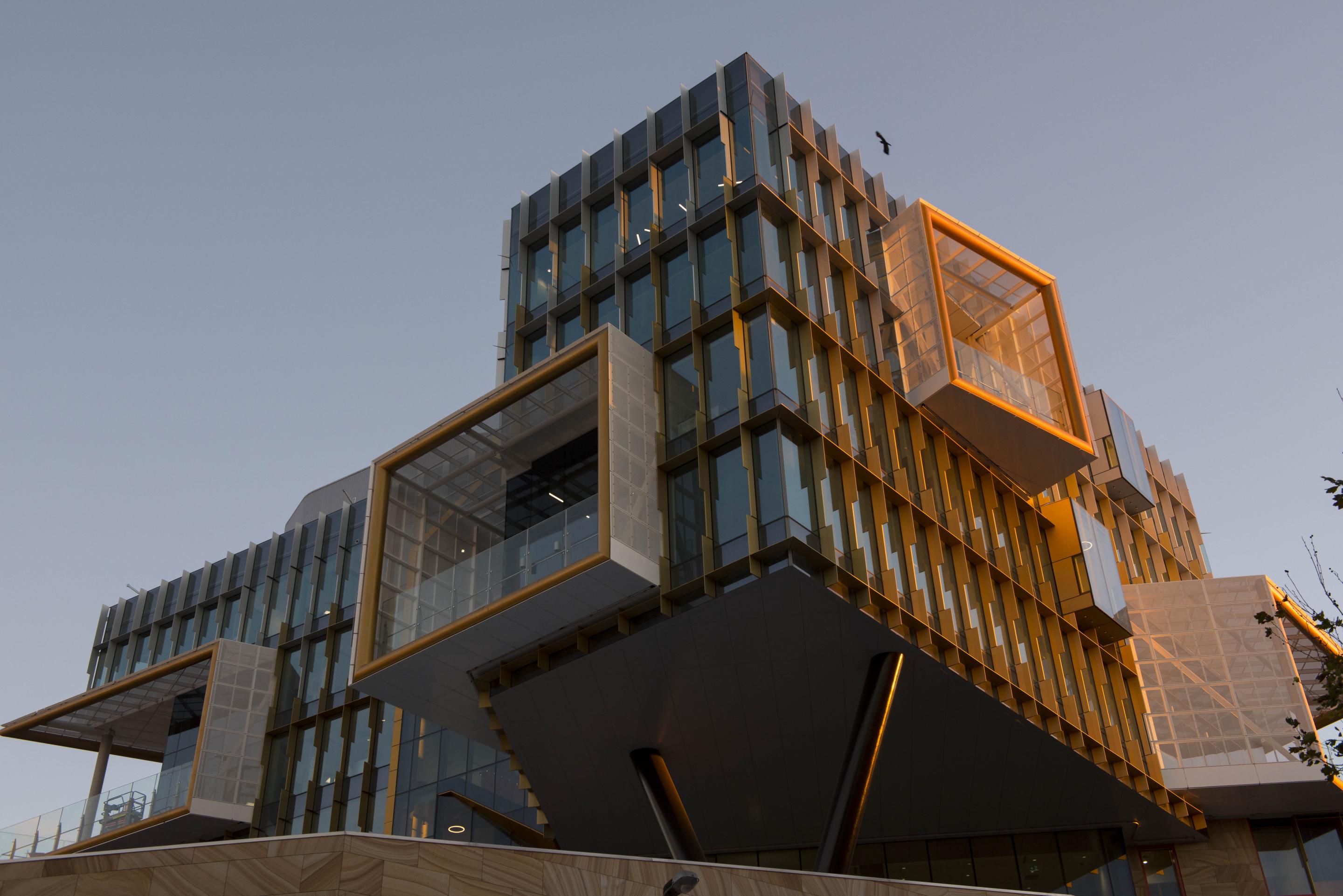 Exterior view of modern, square building with large glass windows