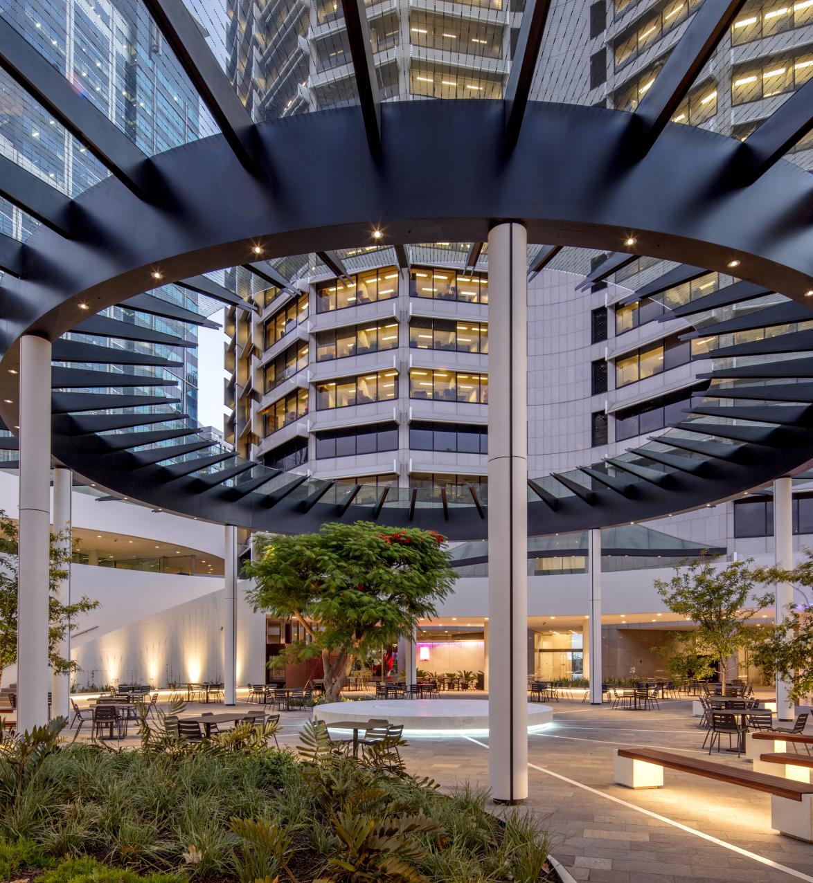 View of seated garden area in modern building under glass roof