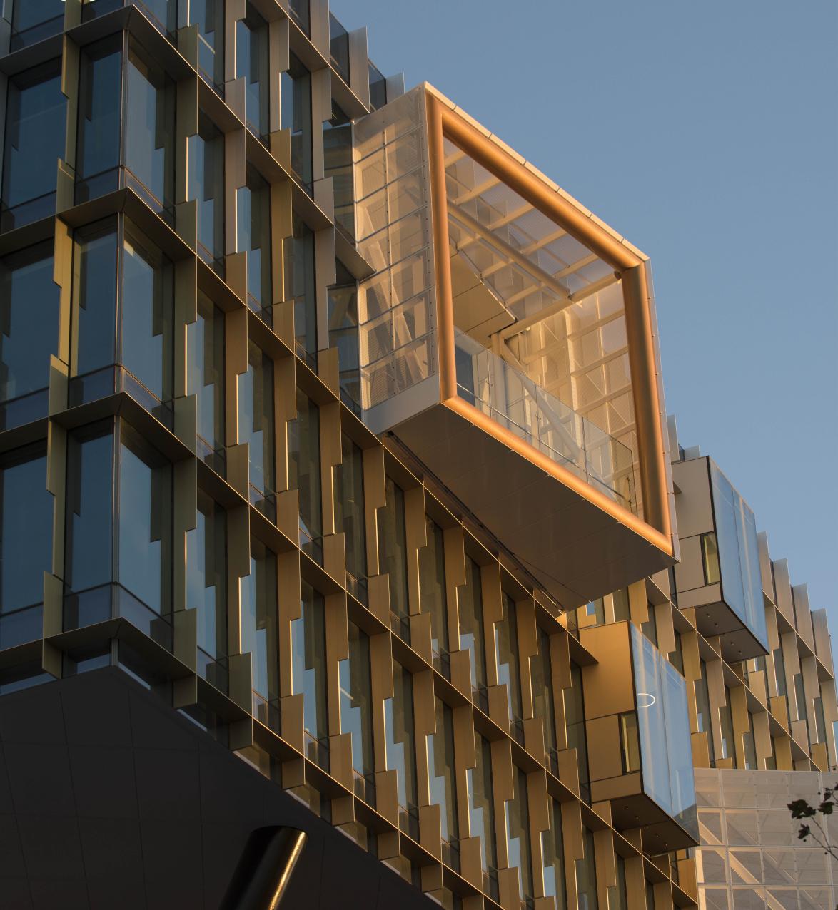 Glass building with sun shining on boxed window