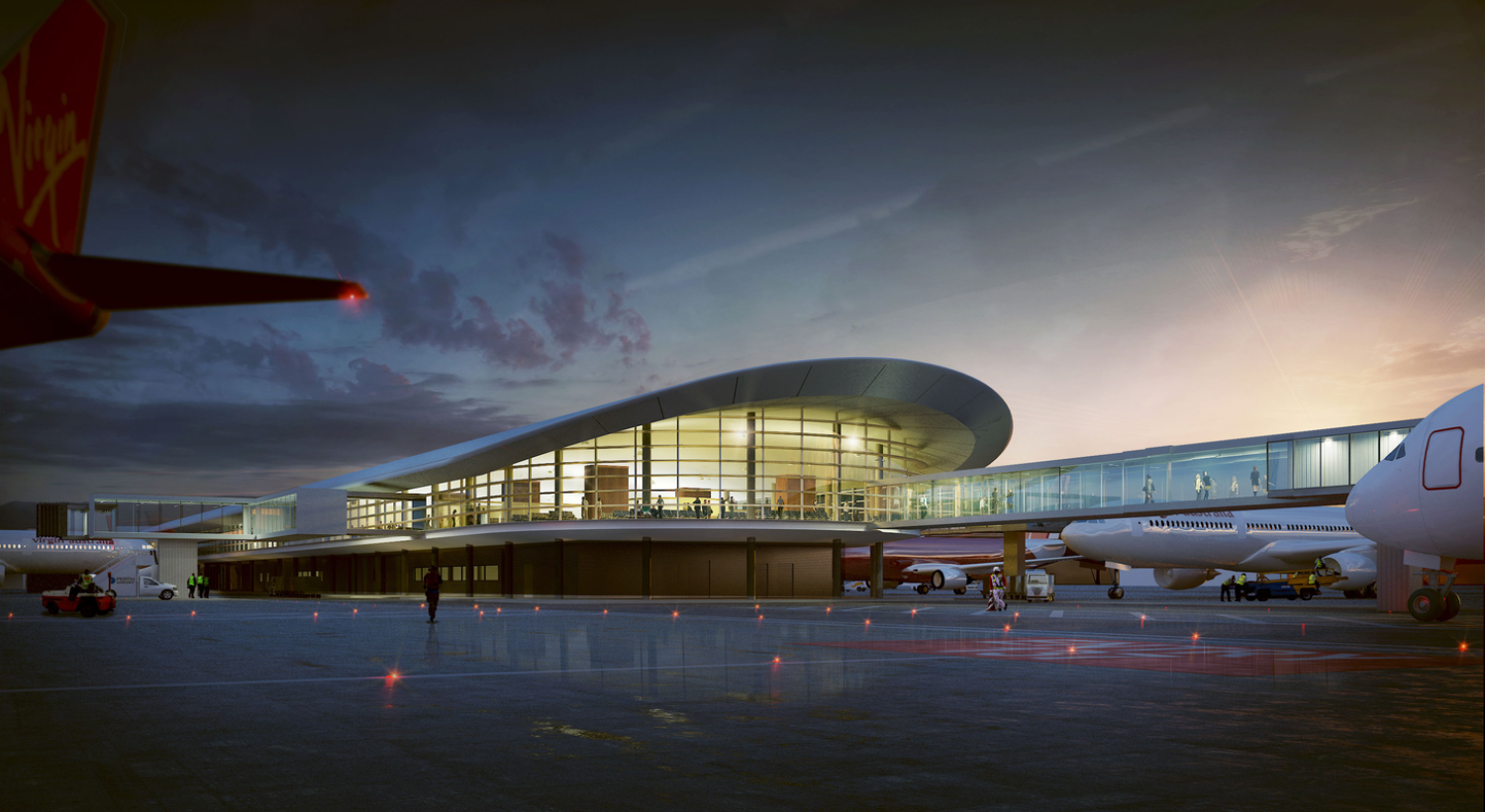 Airport terminal viewed from the runway at sunset