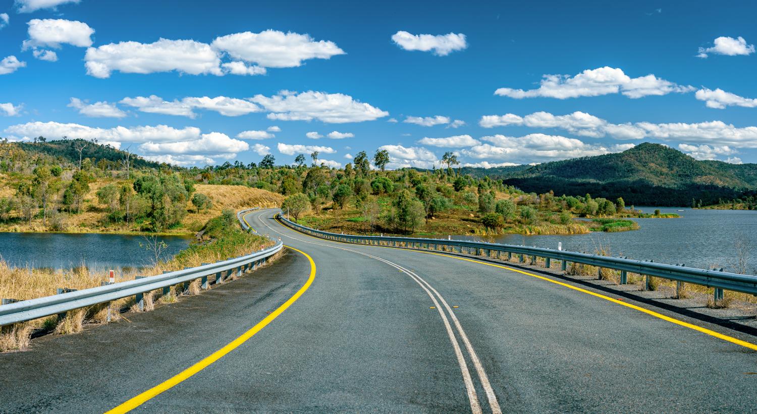 View of road running over dam in Queensland, Australia, on a sunny day