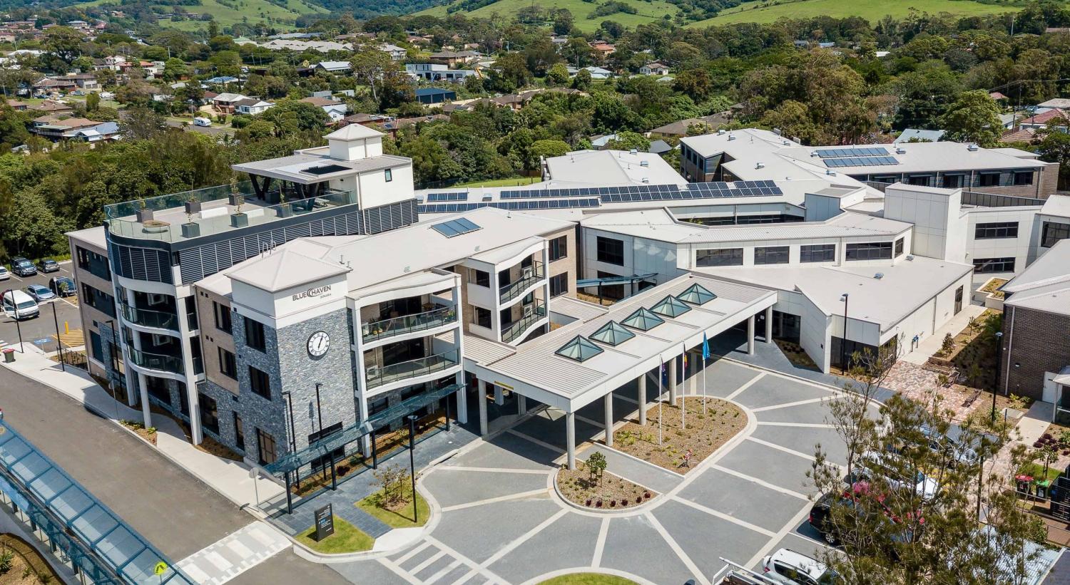 Aerial photograph of large building complex with rooftop garden and solar panels